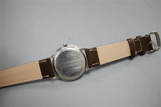 A gentlemans 1960s stainless steel Hamilton automatic wrist watch, with baton numerals and later associated leather strap,
